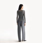 Grey wool layered top in 18 gauge knit with fitted crewneck and dimensional rib jersey texture. rear-view.
