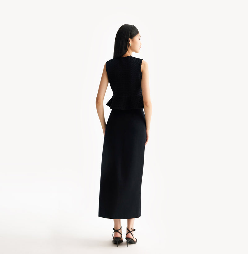 Black wool maxi skirt in thick texture with seamless belt-friendly waistband.rear-view.