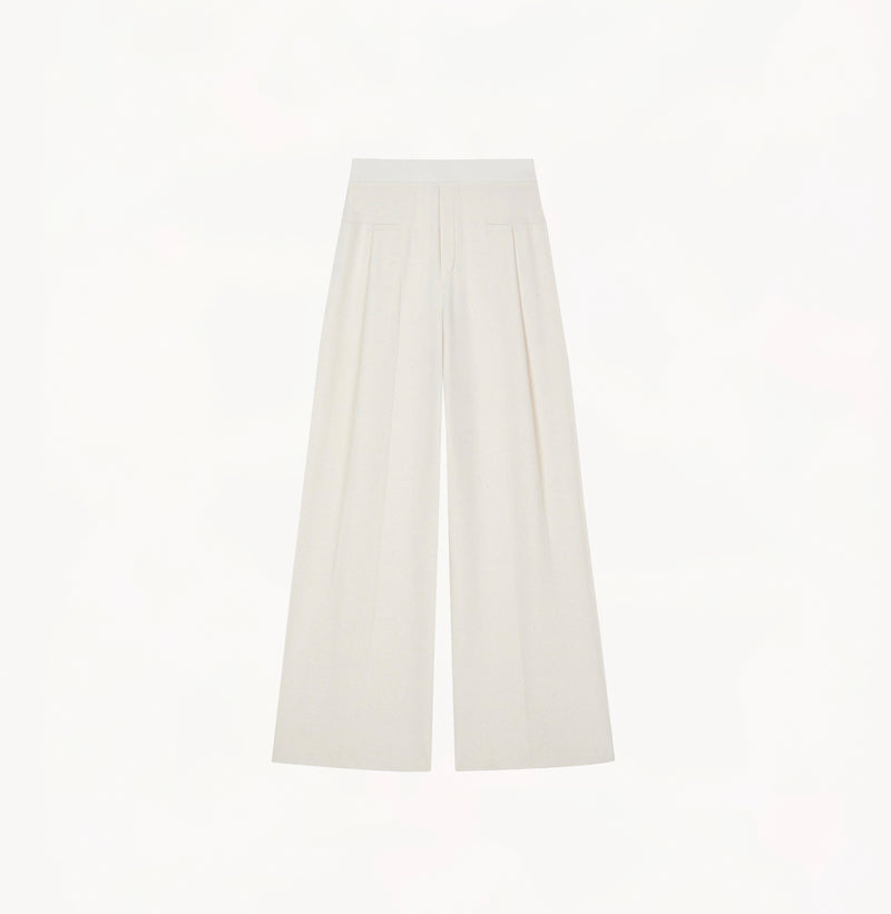 White wool blend wide leg pants with relaxed fit and fluid drape in midweight fabric.
