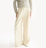 White wool blend wide leg pants with relaxed fit and fluid drape in midweight fabric.left-view.
