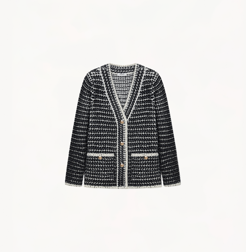 Boucle jacket with a v-neck in black and grey stripes.