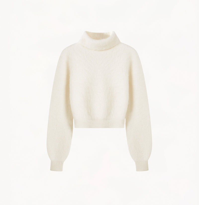 Cropped cashmere turtleneck sweater in white.