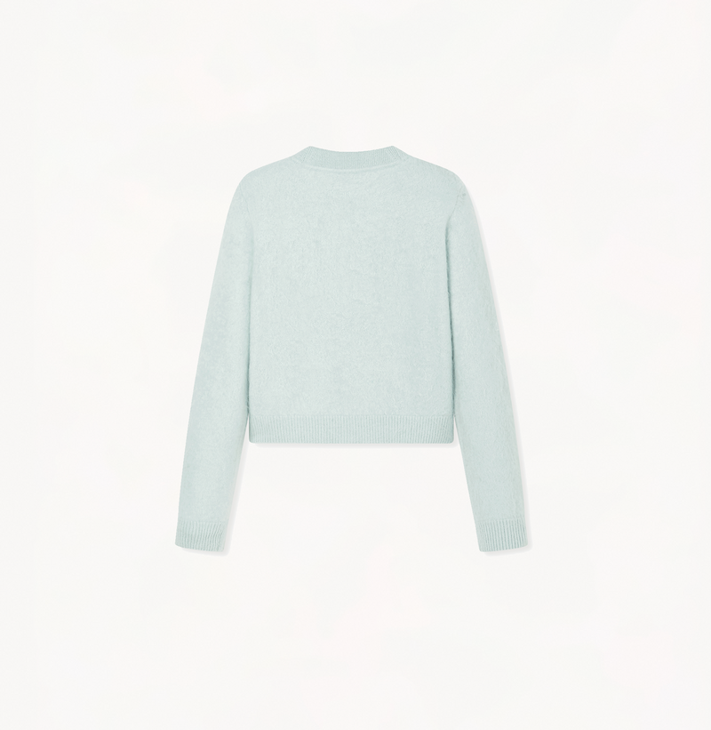 Cropped cashmere cardigan with v-neck in light green.