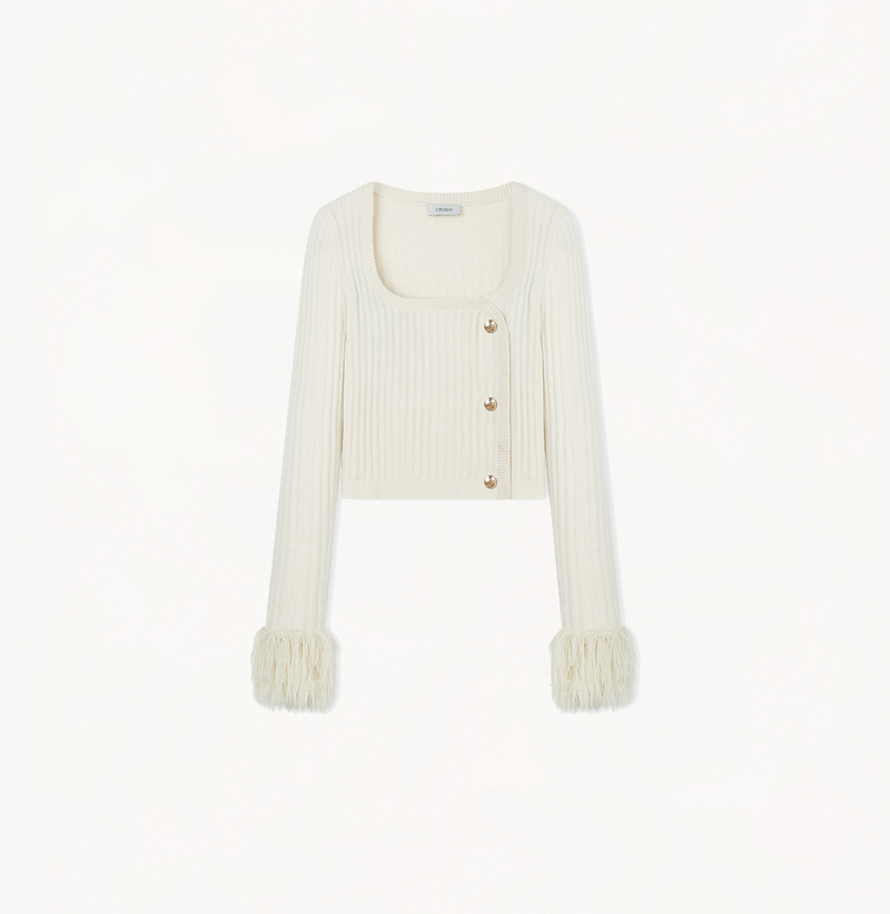 Cashmere sweater with fringe in ivory.