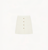 White skirt with pockets and buttons.