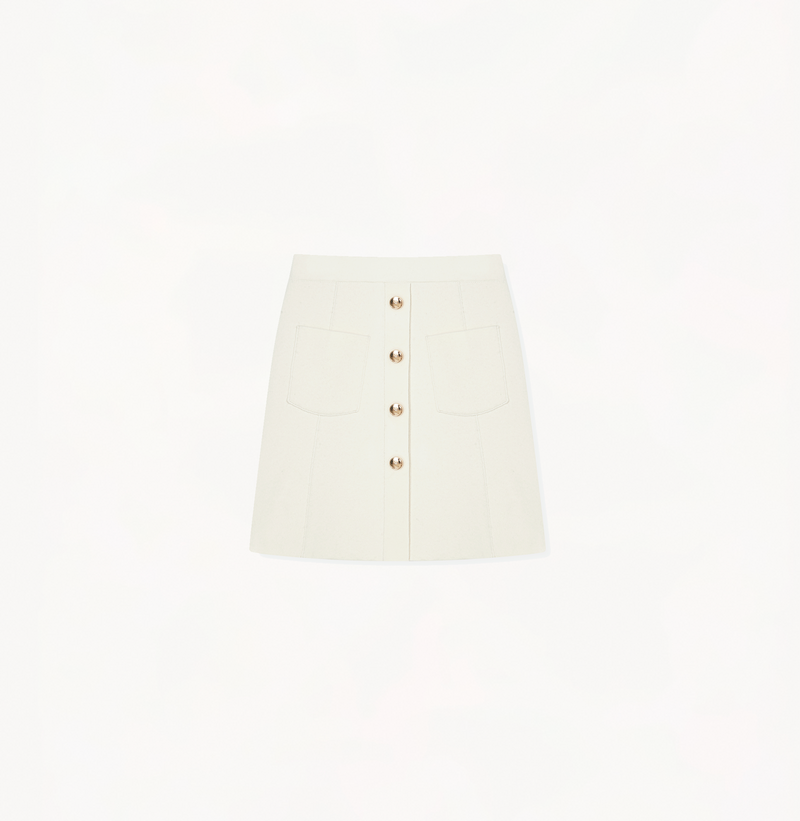 White skirt with pockets and buttons.